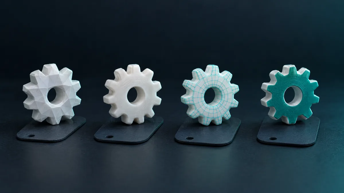 Four 3D-printed gears, each in a style: faceted, smooth, wireframe and painted